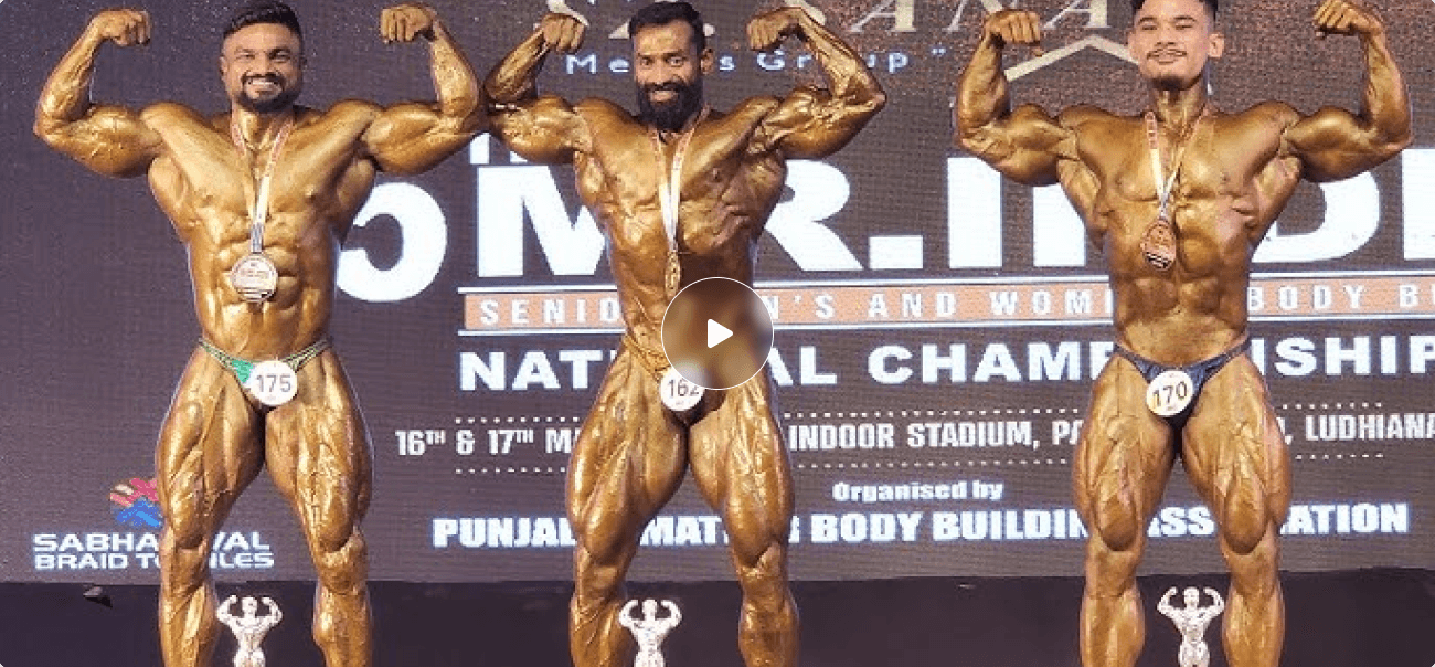 Bodybuilder showing muscular back in gym