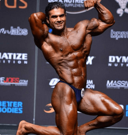 Bodybuilder side chest pose on competition stage