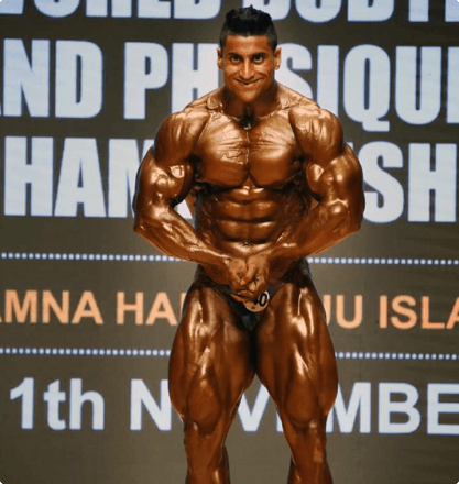 Bodybuilder front pose on competition stage