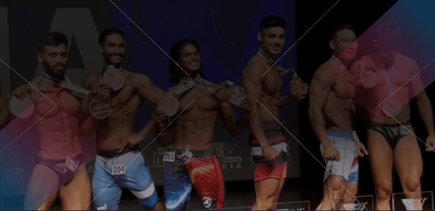 Bodybuilder showing muscular back in gym