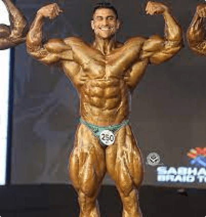 Bodybuilder double bicep pose with gold skin