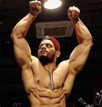 Bodybuilder victory pose with arms raised
