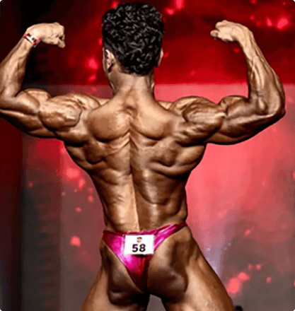 Bodybuilder back double bicep pose with red lighting